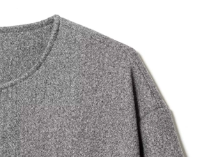 Detail of gray textured wool blend fabric on a collarless bomber jacket with clean seams