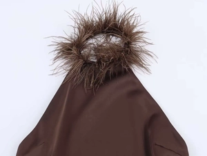 Macro detail of dark brown satin dress with luxurious ostrich feather halter neckline