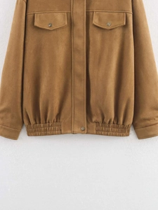 Detail of brown faux suede jacket featuring chest flap pockets and elastic hemline