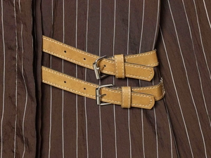 Detail of vintage brown striped shirt featuring double camel leather belts and D-ring buckles