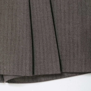 Fashionable dark grey pinstripe pleated skort featuring high-quality herringbone fabric