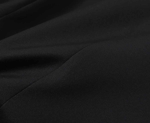 Close-up of premium black twill fabric texture for women's tailored short blazer jacket