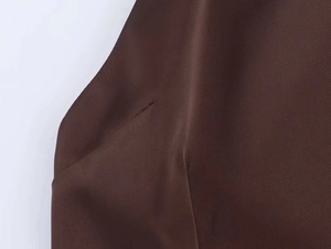 Macro shot of dark brown dress fabric showing the fine weave and seamless texture