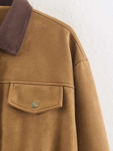 Close-up of faux suede jacket featuring contrast corduroy collar and vintage metal snap button