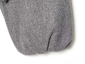 Close-up of soft grey fleece fabric detail on bomber jacket sleeve and cuff texture