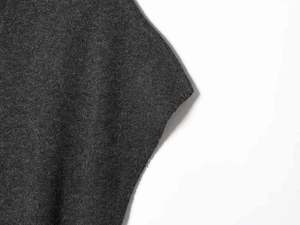 Detailed macro view of dark grey knit fabric texture for V-neck two-piece set