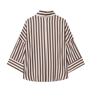 Detail view of brown and white striped shirt showing drop shoulder and mixed patterns