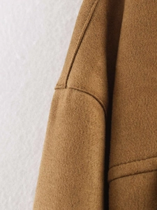 Macro shot of durable suede fabric texture and stitching on brown fashion jacket
