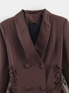 Close-up of deep brown shawl collar blazer with double-breasted buttons and side lacing