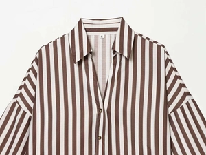 Detail of V-neckline and S-size label on brown and white striped linen-like shirt