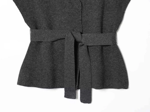 Detailed close-up of dark grey knit fabric with a matching tie belt and fine stitching