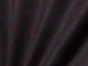 Detailed macro shot of dark brown fabric with a woven geometric diamond pattern
