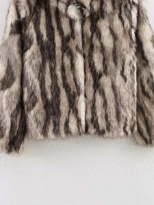 Close-up of luxury faux fur jacket showing rich black and white animal hair texture
