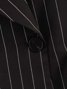 Detailed macro view of pinstripe suit blazer featuring fine stitching and a black button