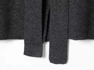 Close-up of charcoal grey knit fabric with detailed rib texture and fine weave pattern