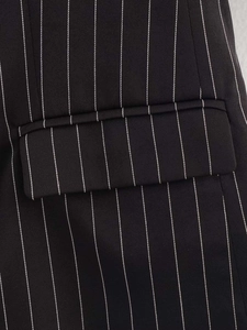 Close-up of the pocket flap and pinstripe texture on the striped suit blazer