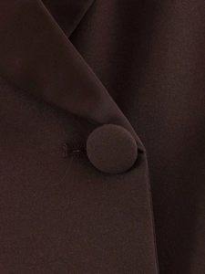 Close-up of the elegant dark brown satin-stitched blazer collar with fabric-covered buttons