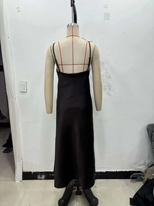Back view detail of elegant black satin maxi dress with thin straps and lace V-neckline