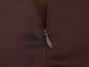 Detail shot of the invisible zipper closure on the dark brown halter neck dress