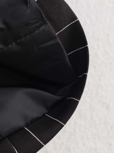 Macro view of striped ribbed cuffs and smooth silk lining on black blazer jacket