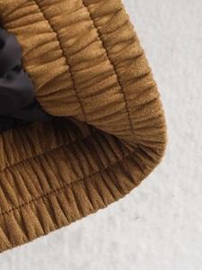 Macro shot of brown corduroy elastic cuffs with smooth lining and fine stitching