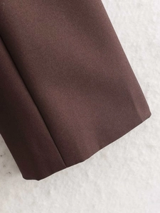 Detailed macro shot of dark brown twill fabric texture and draped satin lining material