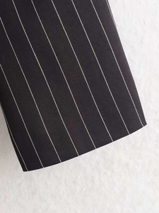 Detailed close-up showing the premium pinstripe fabric texture and stitching of the blazer