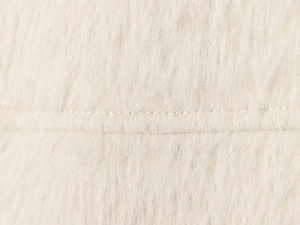 Detailed macro shot of plush beige fleece fabric texture and neat horizontal stitching