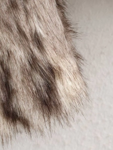 Close-up macro view of premium faux fur texture in blended brown and grey tones