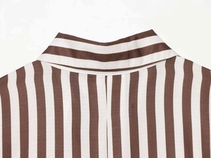 Detail view of the V-neckline on this vintage brown and white striped cotton shirt
