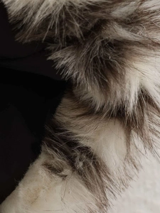 Macro detail of the plush faux fur collar featuring multi-color brown and beige fibers