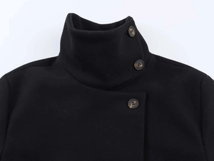 Close-up of black wool jacket high stand collar with tortoiseshell textured buttons