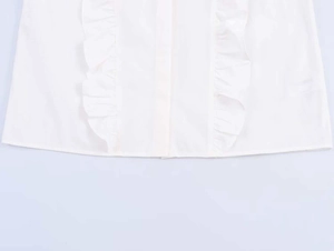 Detail of white cotton poplin shirt showing symmetrical ruffles and neat stitching