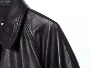 Detail view of premium black faux leather jacket collar and shoulder stitching craftsmanship