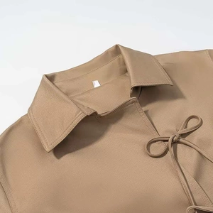 Minimalist khaki cropped jacket for women featuring a lapel collar and front bow tie closure