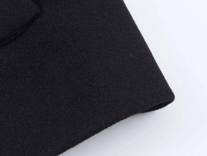 Close-up of high-quality black wool blend fabric showing thick textured wool material
