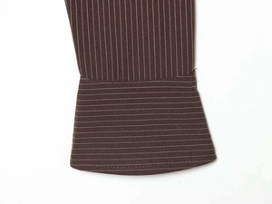 Detail view of brown striped fabric with vertical and horizontal pattern alignment on a shirt