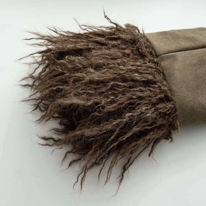 Close-up detail of olive green faux suede fabric with thick brown faux fur trim texture