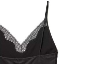 Detailed view of black satin V-neck camisole dress featuring delicate eyelash lace trim