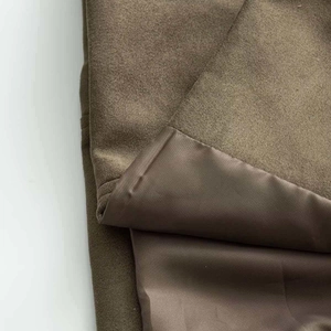 Detail shot of brown faux suede fabric and smooth satin lining of the vintage coat