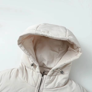 Close-up of quilted hooded puffer jacket showing drawstring toggles and metal zipper details