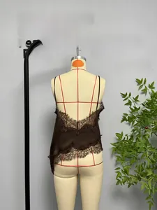 Close-up of brown silk satin camisole with delicate eyelash lace hem and open back detail