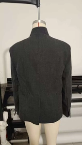 Detail view of the back stand-up collar on a dark grey textured mixed-blend blazer jacket