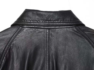 Close-up detail of the collar and shoulder stitching on a black leather jacket