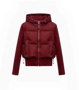 Close-up of hooded wine red puffer jacket featuring mixed material and zip pockets