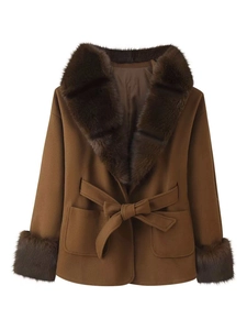 Detail of camel wool coat featuring luxurious dark brown faux fur trim on collar and cuffs