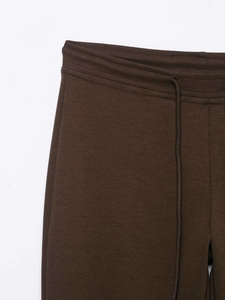 Detail of high waist chocolate brown joggers with adjustable drawstring and elastic waistband