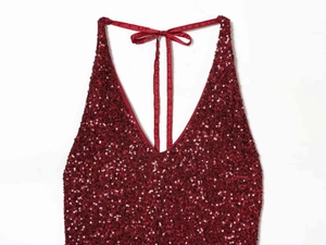 Detail view of the deep red sequin halter dress with a satin bow at the neckline