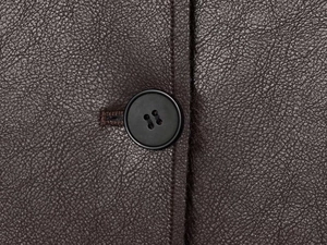 Detail of dark brown leather jacket showing lychee grain texture and sewing craftsmanship