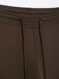 Detail of high waist adjustable drawstring on dark brown casual flared trousers